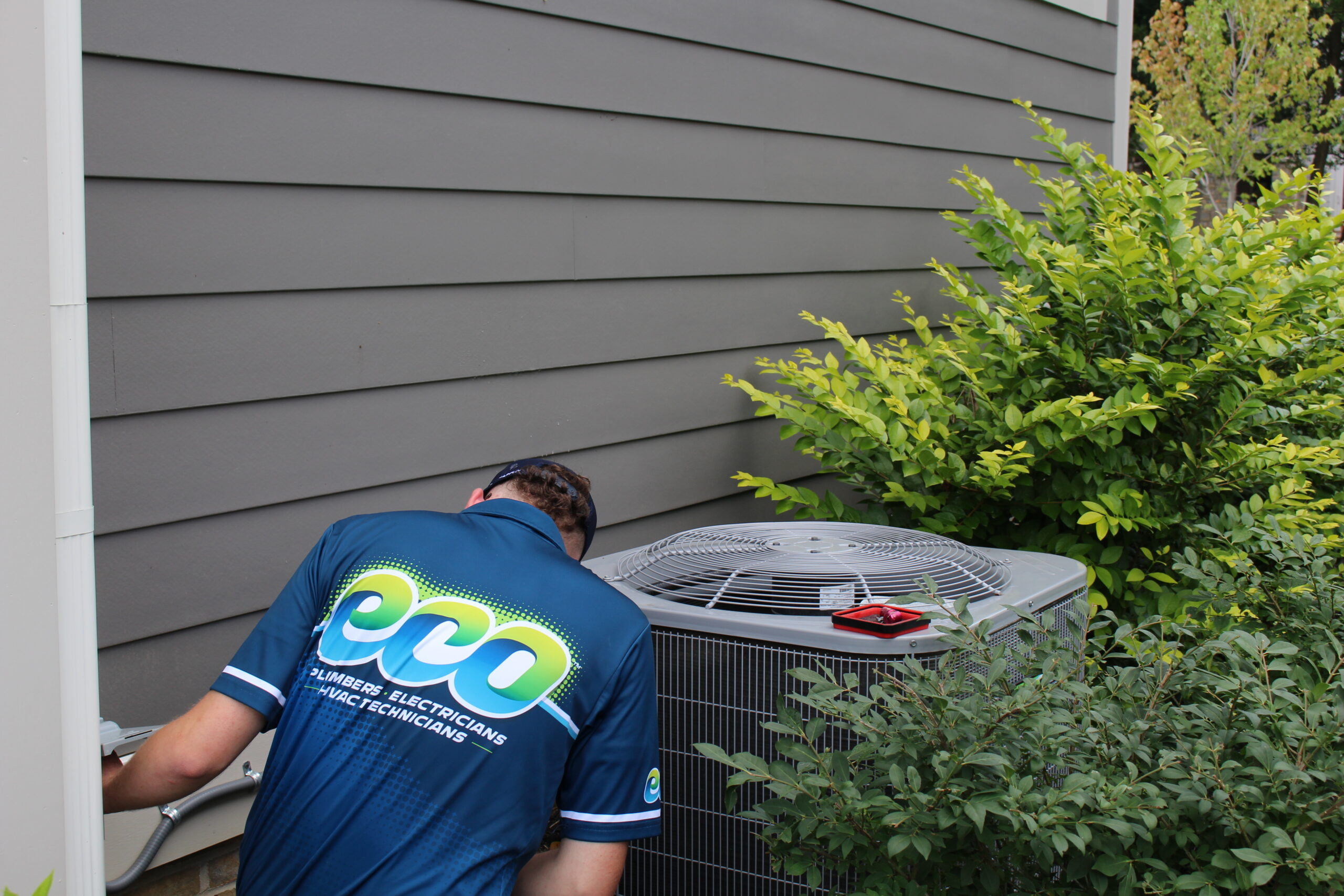 HVAC technician performing air handler installation and repair in a residential HVAC system