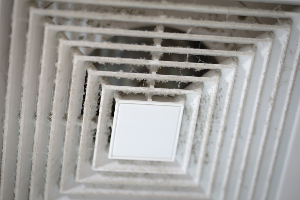 HVAC technician inspecting dirty air ducts in a Chillicothe, OH home