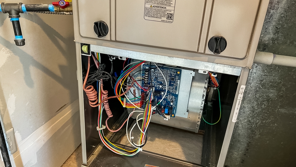 HVAC technician inspecting a gas furnace with a burning smell in a Chillicothe, OH home