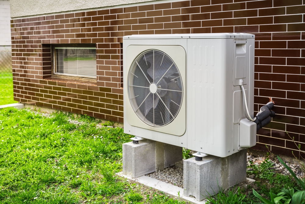HVAC professional calculating the break-even point for heat pump replacement