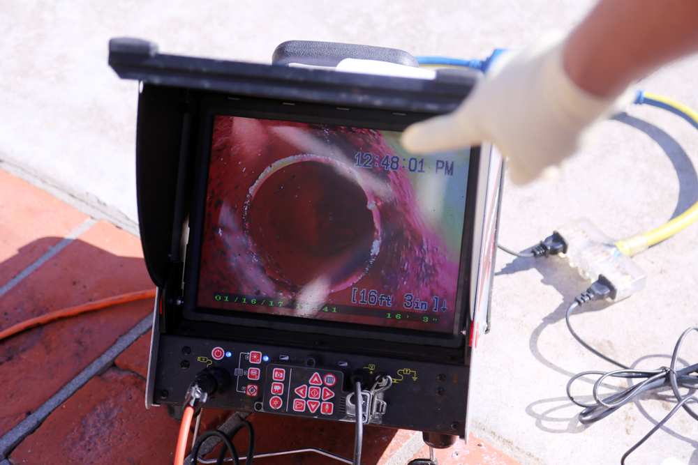 Plumber performing a sewer camera inspection to detect hidden pipe problems