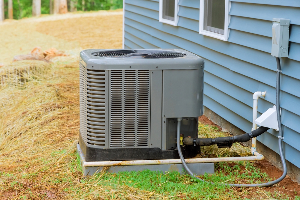 Professional HVAC technician completing AC installation in a home with a new energy-efficient cooling system