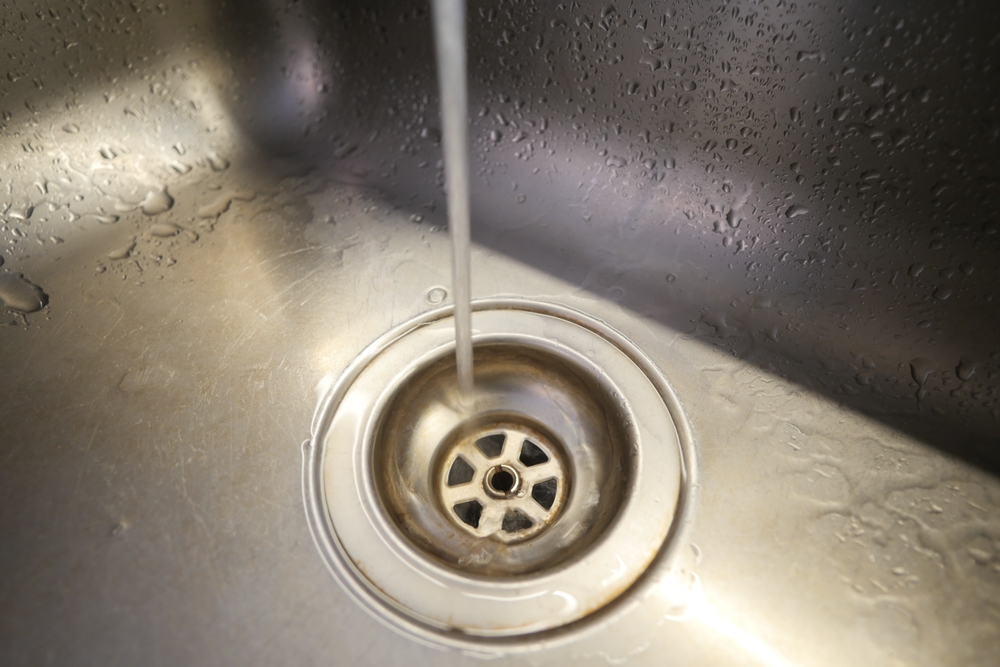 Plumber inspecting a drain cleanout at a Cincinnati, OH home