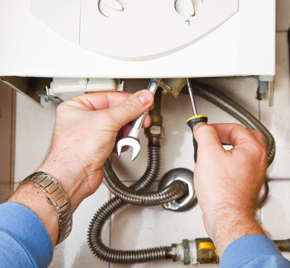 Plumber troubleshooting tankless water heater error codes in a Cincinnati, OH home