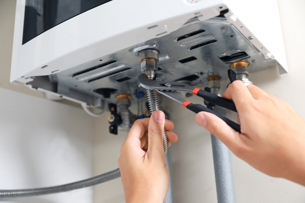 Plumber diagnosing common water heater problems in a Cincinnati, OH home