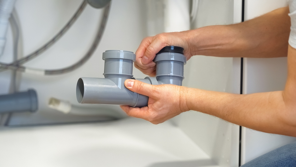 Professional plumbing company in Cincinnati inspecting residential pipes to help protect a home from plumbing damage