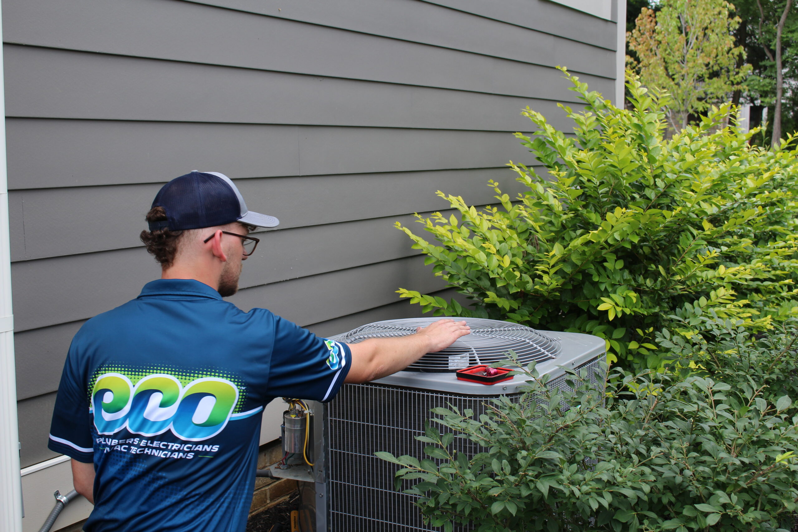 HVAC technician preparing a new air conditioning installation quote for a homeowner