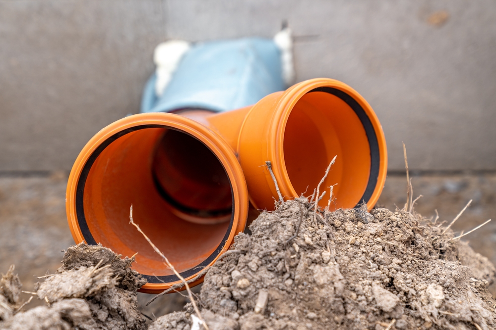 Professional plumber performing sewer line cleaning at a Dayton, OH home