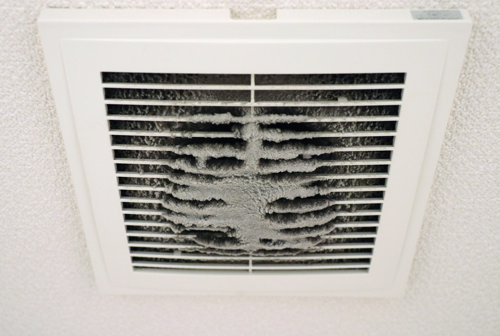 HVAC technician performing air duct cleaning to improve indoor air quality in a Dayton, OH home