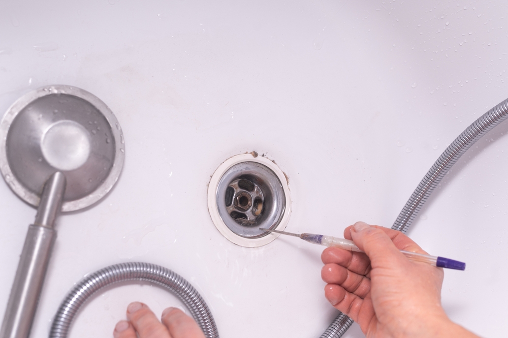 Professional providing clogged drain service in Dayton, OH