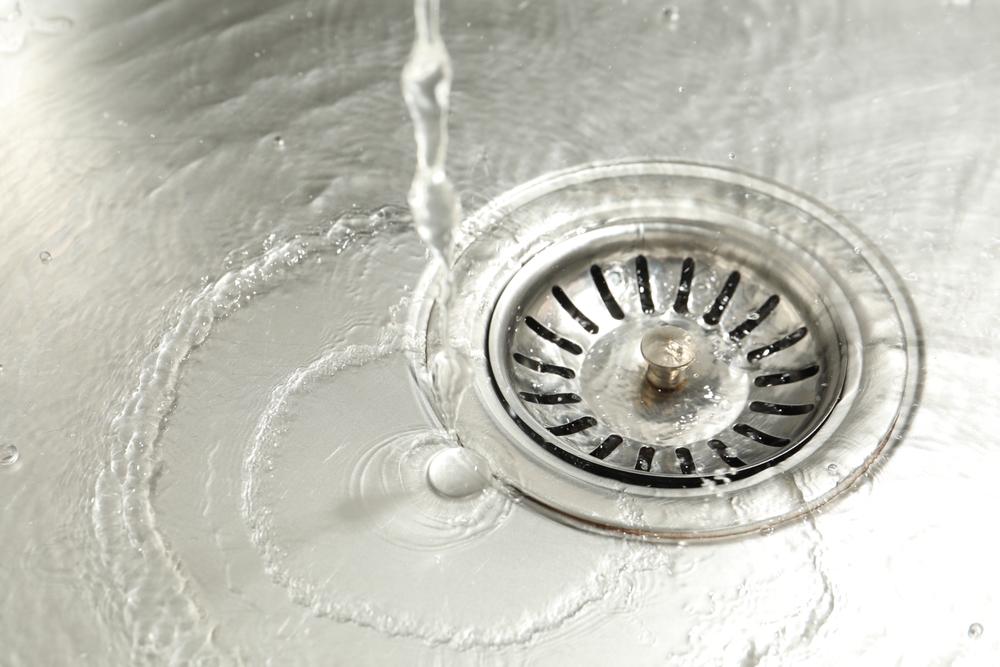 Homeowner following a seasonal drain cleanout checklist